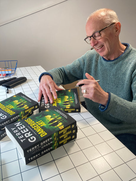 Terry Green signing copies of his book Dangerous Art at Gumshoe Books